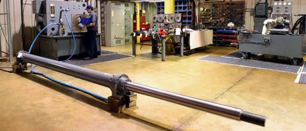 Technician using a test bench during a hydraulic cylinder repair